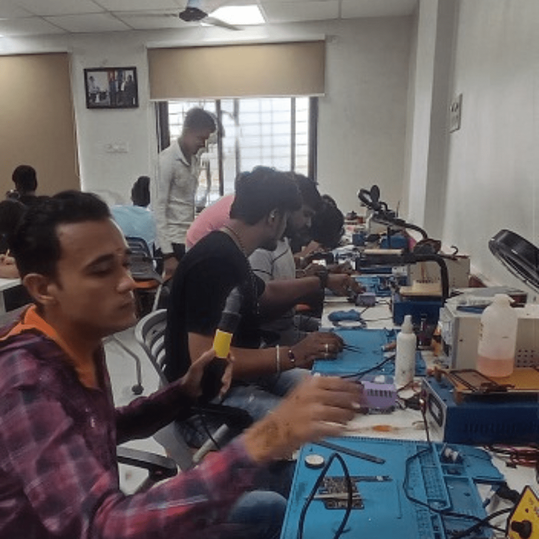 Student practicing mobile phone repair